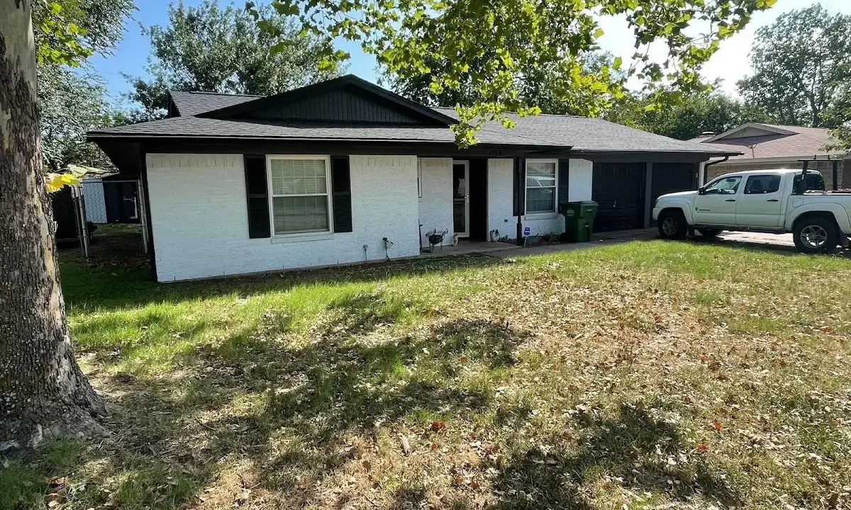 Professional roofing crew working on a residential roof in Laconia